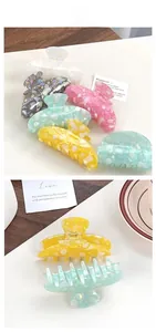 Macro view of colorful marble pattern PVC hair claws with strong metal spring mechanism