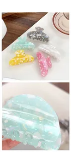 Macro detail of multi-color PVC claw clips with natural marbled texture and shell finish