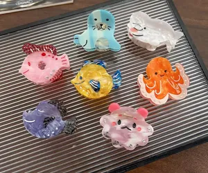 Detailed close-up of marine-themed acetate hair claws in various colorful animal shapes