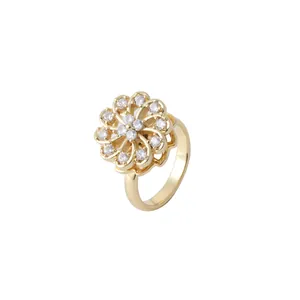 Golden rotating flower ring with sparkling white cubic zirconia stones in a minimalist design