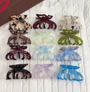 Dettaglio di 12 fermagli per capelli in acetato colorato con motivi e texture eleganti