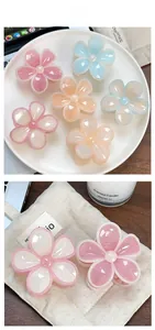 Detail of candy-colored plumeria flower hair claws in a refined lifestyle setting