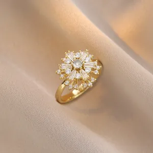 Golden snowflake spinning ring with sparkling white zircon stones on champagne silk