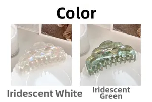 Detail of oversized wavy claw clips in iridescent white and colorful green finishes