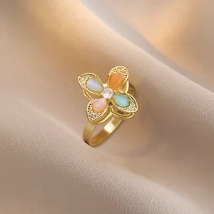 Elegant gold ring with four-color cat eye stones in a flower shape and zircon center