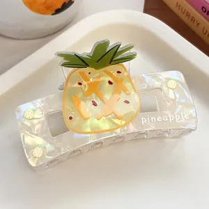 Detail of translucent pineapple hair claw clip with colorful iridescent finish and text