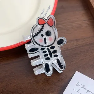 Detail of cartoon ghost hair claw clip with marble texture on a decorative table