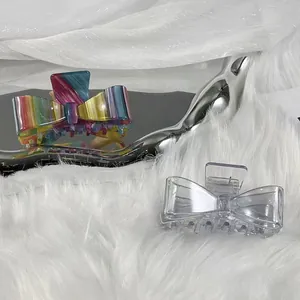 Elegant acetate bow hair claw clips in colorful iridescent and transparent finishes