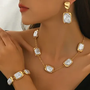 Vintage gold jewelry set with geometric faux pearls featuring necklace bracelet earrings