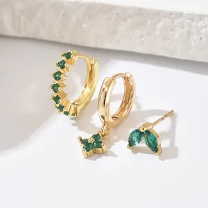 Three-piece gold earring set featuring green zircon gemstones and a clover charm