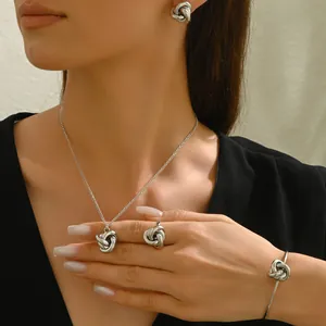 Silver twist jewelry set with necklace earrings and open bangle on a model