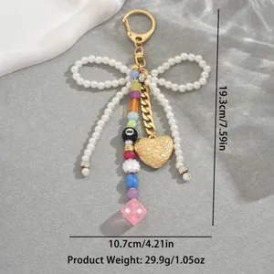 Handmade pearl bow keychain with heart pendant and mixed charm beads for women