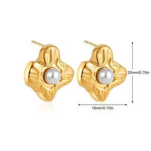 Detail showing petal-shaped gold metal earrings with faux pearl center and 20mm height