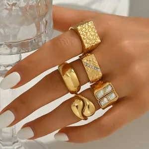 Luxury 5-piece gold geometric ring set with pearl and zircon accents on model hand