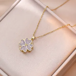 Golden clover necklace with purple zircon inlay displayed in a premium jewelry box