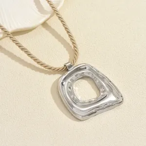 Minimalist silver irregular hollow pendant necklace with hammered texture on a cord