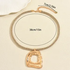 Golden rope chain necklace with a large irregular hollow geometric pendant and 38cm chain length