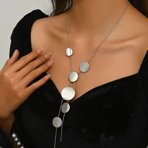 Silver geometric necklace with tiered round metal discs on elegant long link chain