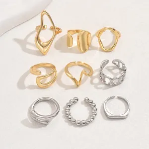Nine-piece minimalist gold and silver ring set featuring open bands and pearl accents