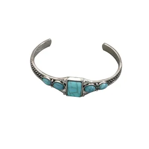 Vintage bohemian open cuff bracelet featuring geometric turquoise stone inlays on silver metal
