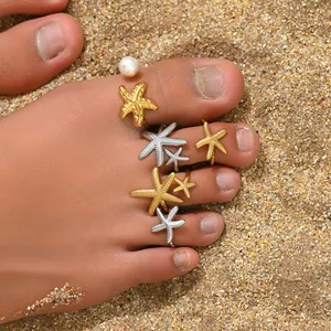 Starfish toe ring set with pearls on beach sand, bohemian ocean style gold jewelry