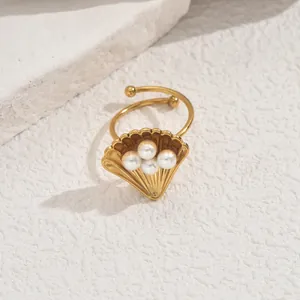 Minimalist shell ring with white pearls in gold finish for a marine ocean style look