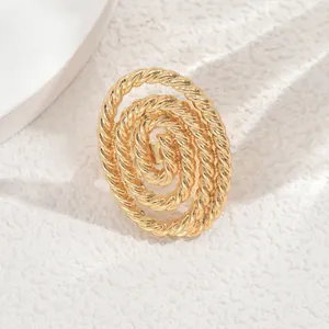 Baroque style gold statement ring featuring rope twist texture and geometric floral design