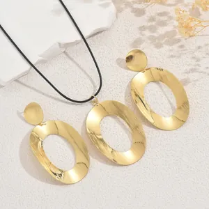 Minimalist gold jewelry set with geometric oval pendant necklace and earrings