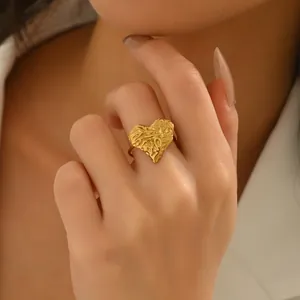 Elegant 18k gold plated heart ring with unique textured design on model's hand