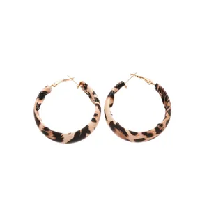 Retro leopard print leather hoop earrings with gold hardware for women, autumn fashion.