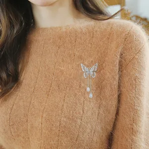 Elegant butterfly tassel brooch with sparkling zircon inlays on a stylish knit sweater