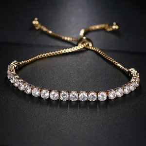 Detail of adjustable gold tennis bracelet with brilliant white cubic zirconia on black backdrop