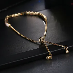 Macro detail of adjustable gold bolo slider and box chain with colorful square-cut zircons