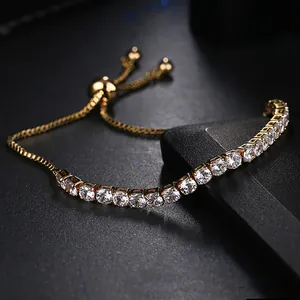 Detail of adjustable gold tennis bracelet featuring zircon stones and drawstring closure