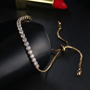 Detail of gold adjustable tennis bracelet with sparkling zircon crystals and slide clasp