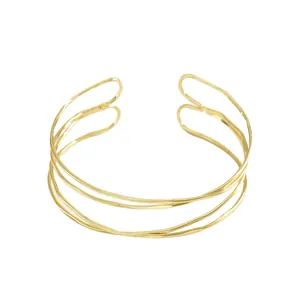 Bracciale rigido dorato minimalista a più strati con linee geometriche ondulate