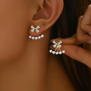 Elegant gold bow earrings with crystal pave and pearl ear jacket for women