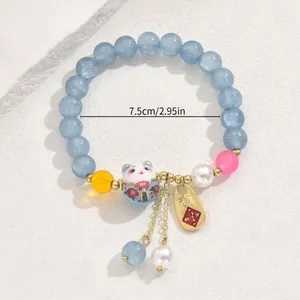 Glückskatze Perlenarmband mit hellblauen Perlen und goldenen Quasten, 7,5 cm Durchmesser