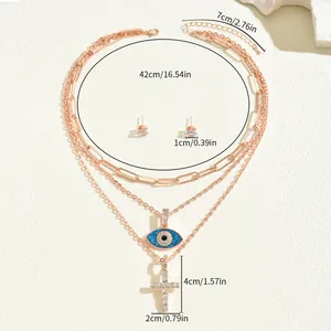 Roségoldene Halskette im Layering-Look mit blauem Auge des Teufels und Kreuz