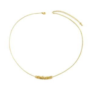 Women gold necklace with geometric textured pendant and crystals on a fine chain
