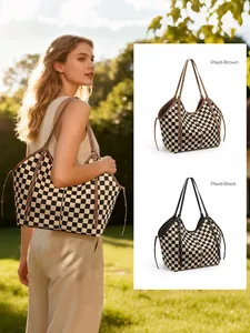 Detail view of plaid tote bag in brown and black colors showing side straps and texture