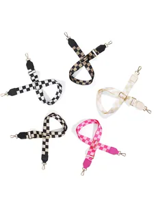 Close-up of five adjustable checkered guitar straps with premium gold metal buckles