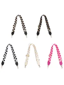 Close-up of five adjustable checkerboard guitar straps with gold metal clasps and leather ends