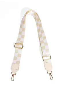 Close-up of adjustable beige checkered strap with premium gold hardware and lobster clasps