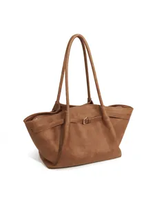 Detail view of brown dumpling tote bag with leather buckle and pleated design
