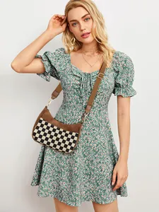 Detail of checkered crossbody crescent bag with adjustable wide strap on model