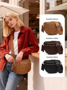 Detailed view of suede crossbody bag with dual zipper compartments and adjustable strap