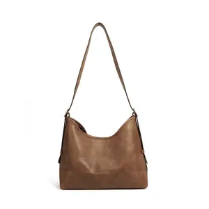 Brown vintage faux leather hobo tote bag for women featuring minimalist shoulder strap design