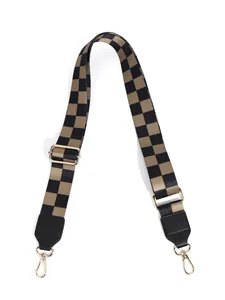 Adjustable checkerboard bag strap with golden hardware and black leather connectors