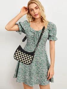 Detail view of checkerboard crescent bag with adjustable strap and spacious interior